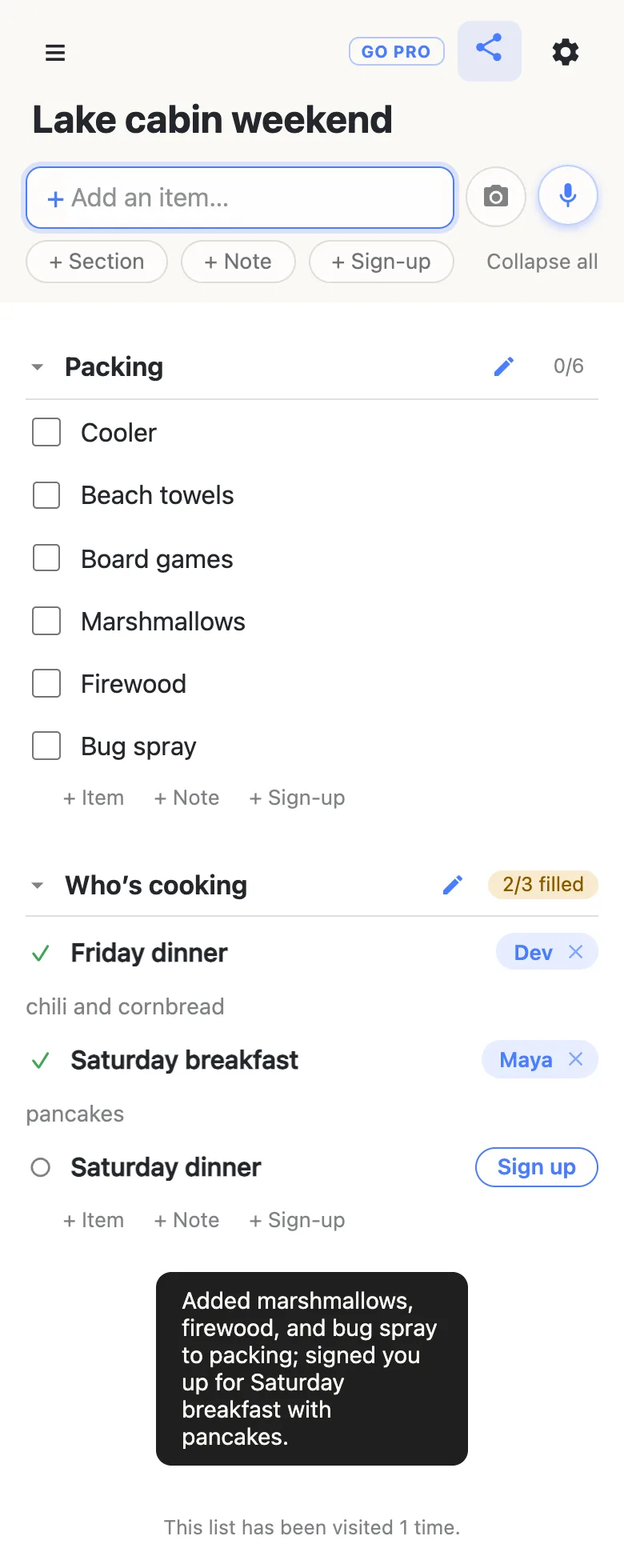 The same list a few seconds later: Packing now has six items including Marshmallows, Firewood and Bug spray, the Saturday breakfast slot is filled by Maya with the note “pancakes”, the section counter reads 2/3 filled, and a dark toast at the bottom summarises what the assistant did.