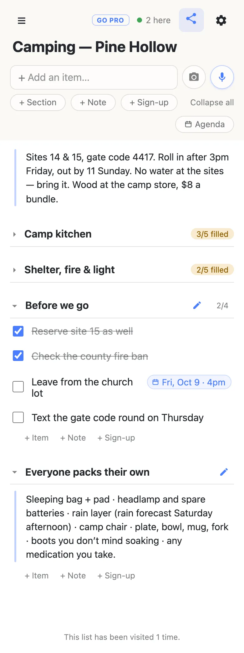 The same list with the two gear sections folded shut, their counters still on the headings: Camp kitchen 3/5 filled, Shelter fire & light 2/5 filled. A Before we go section is open with two tasks struck through, an unticked row reading “Leave from the church lot” carrying a date chip “Fri, Oct 9 · 4pm”, and one more unticked row. Below it, a section called Everyone packs their own holds a single note block listing sleeping bag, headlamp, rain layer, camp chair, dishes and boots. A chip in the header reads “2 here” with a green dot.