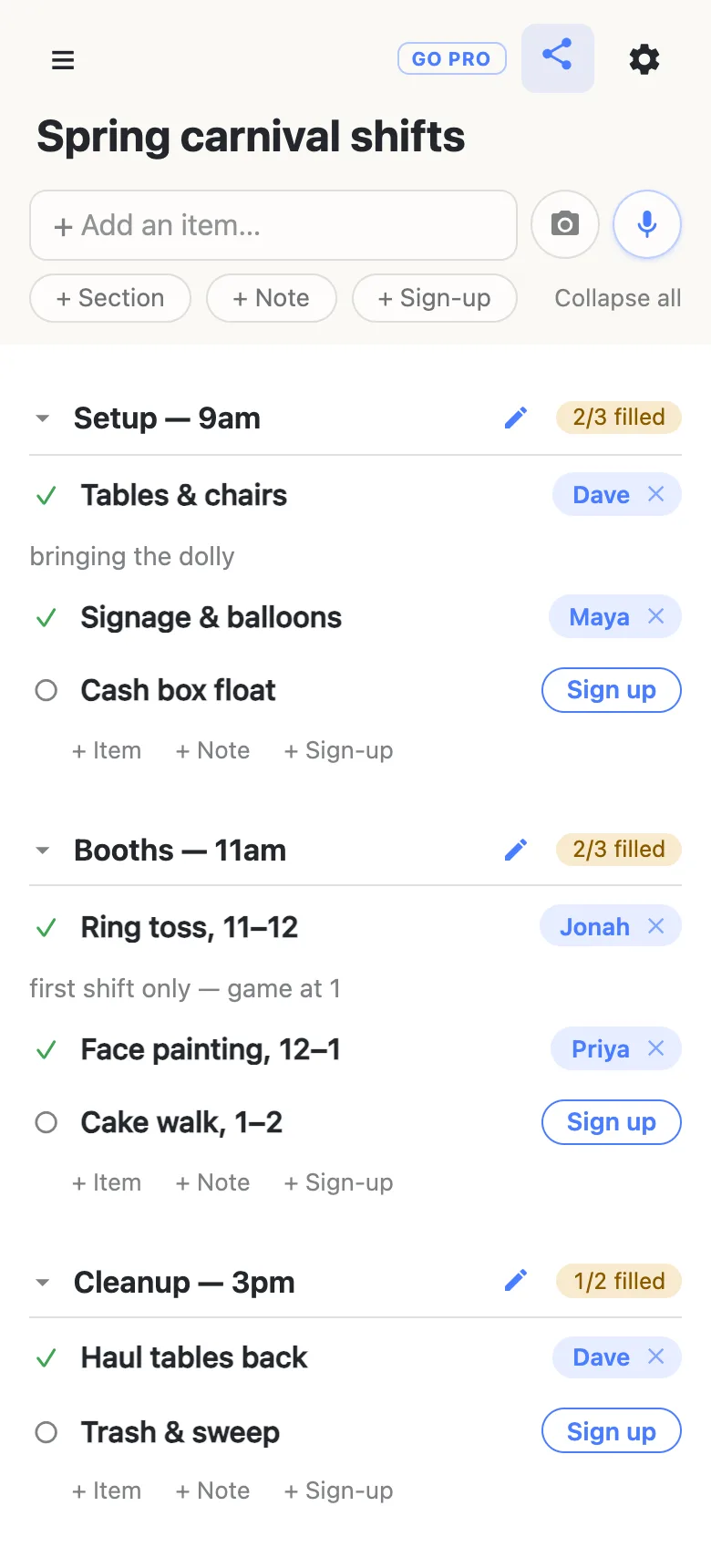 A shared sign-up sheet titled “Spring carnival shifts” on a phone, in three sections. Setup — 9am reads 2/3 filled, with Dave on Tables & chairs (note: bringing the dolly), Maya on Signage & balloons, and Cash box float still open. Booths — 11am reads 2/3 filled, with Jonah on Ring toss 11–12 (note: first shift only — game at 1) and Priya on Face painting. Cleanup — 3pm reads 1/2 filled, with Dave on Haul tables back.