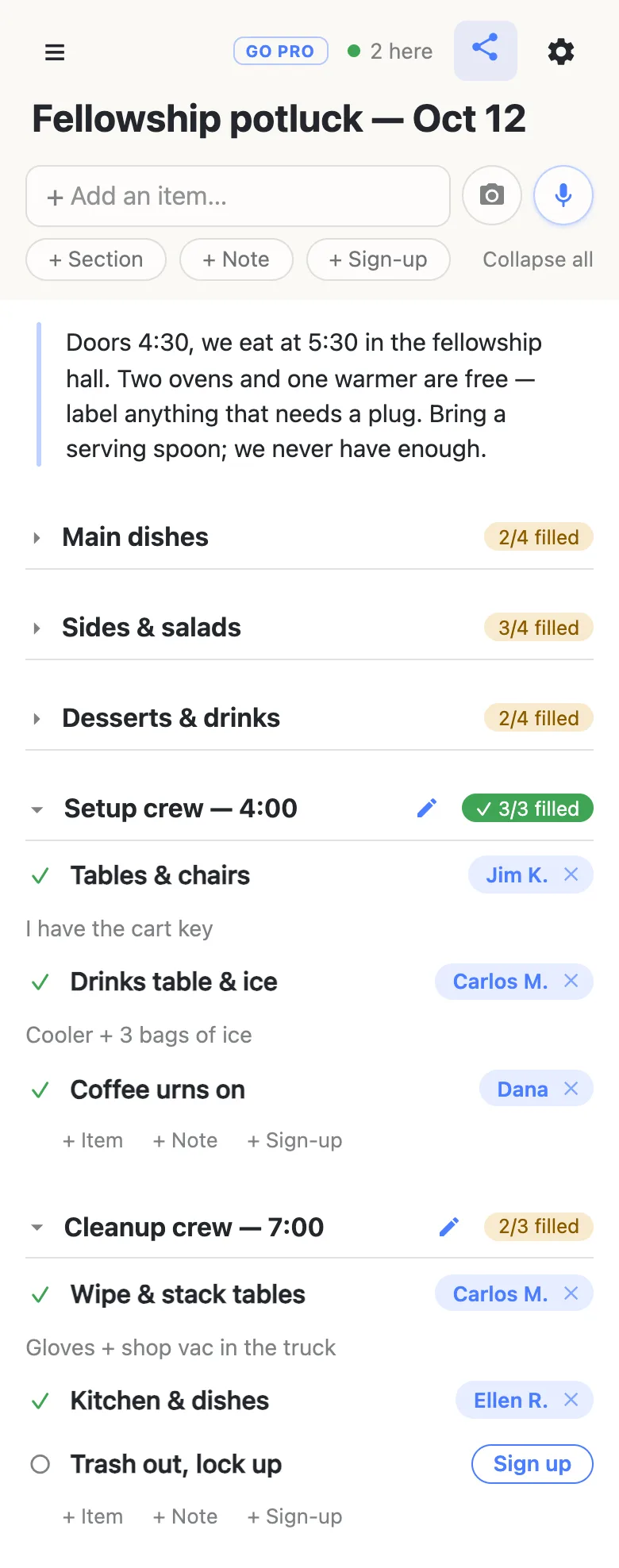 The same sheet with the three food sections folded shut, their counters still on the headings: Main dishes 2/4 filled, Sides & salads 3/4 filled, Desserts & drinks 2/4 filled. Setup crew — 4:00 is open and reads a green 3/3 filled, with Jim K. on tables and chairs (“I have the cart key”), Carlos M. on the drinks table (“Cooler + 3 bags of ice”) and Dana on the coffee urns. Cleanup crew — 7:00 reads 2/3 filled with one row still open. A chip in the header reads “2 here” with a green dot.