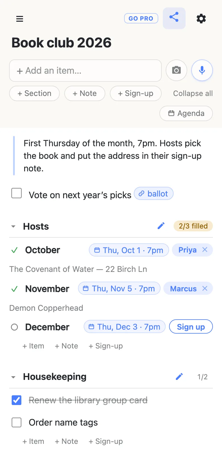 A phone showing a list titled “Book club 2026”. A note reads “First Thursday of the month, 7pm. Hosts pick the book and put the address in their sign-up note.” Below it an unticked row “Vote on next year’s picks” carries a link chip reading “ballot”. A section headed “Hosts”, marked 2/3 filled, has three sign-up rows with date chips: October, Thu Oct 1 · 7pm, claimed by Priya with the note “The Covenant of Water — 22 Birch Ln”; November, Thu Nov 5 · 7pm, claimed by Marcus with the note “Demon Copperhead”; and December, Thu Dec 3 · 7pm, still showing a Sign up button. A second section, “Housekeeping”, marked 1/2, has “Renew the library group card” ticked and struck through, and “Order name tags” unticked.