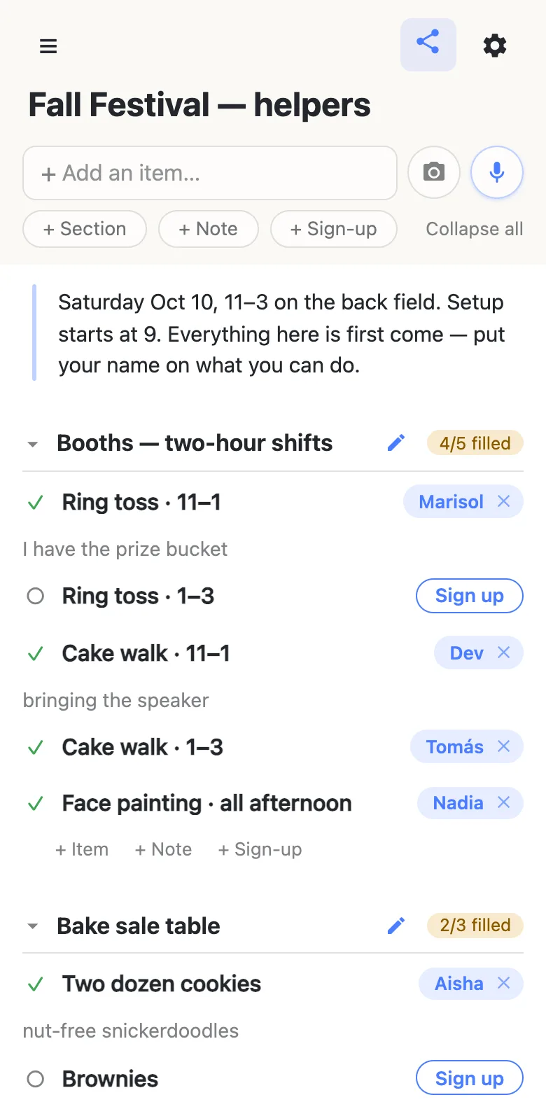 A phone showing a list titled “Fall Festival — helpers”. A note at the top reads “Saturday Oct 10, 11–3 on the back field. Setup starts at 9. Everything here is first come — put your name on what you can do.” Below it a section headed “Booths — two-hour shifts” carries an amber 4/5 filled counter: Ring toss 11–1 claimed by Marisol with the note “I have the prize bucket”, Ring toss 1–3 still showing a blue Sign up button, Cake walk 11–1 claimed by Dev, Cake walk 1–3 by Tomás and Face painting by Nadia. A second section, Bake sale table, reads 2/3 filled.