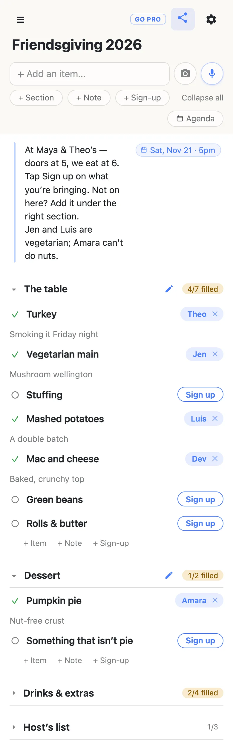 A phone showing a list titled “Friendsgiving 2026”. A note at the top, with a date chip reading Sat, Nov 21 · 5pm, says: At Maya & Theo’s — doors at 5, we eat at 6. Tap Sign up on what you’re bringing. Not on here? Add it under the right section. Jen and Luis are vegetarian; Amara can’t do nuts. The section The table reads 4/7 filled: Theo has the Turkey (“Smoking it Friday night”), Jen the Vegetarian main (“Mushroom wellington”), Luis the Mashed potatoes (“A double batch”) and Dev the Mac and cheese (“Baked, crunchy top”), while Stuffing, Green beans and Rolls & butter each show a Sign up button. Dessert reads 1/2 filled: Amara has the Pumpkin pie (“Nut-free crust”) and Something that isn’t pie is open. Drinks & extras (2/4 filled) and Host’s list (1/3) are folded shut.