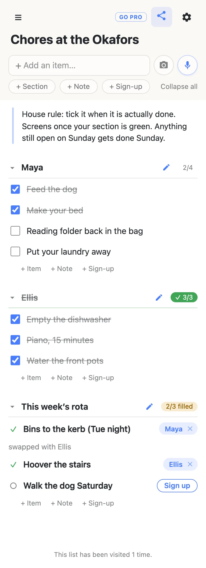 A chore chart on a phone titled “Chores at the Okafors”: a note at the top with the house rule, a “Maya” section reading 2/4 with two chores struck through, an “Ellis” section reading ✓ 3/3 in green with everything done, and a “This week’s rota” section reading 2/3 filled where the bins are claimed by Maya with a note saying “swapped with Ellis”, the stairs by Ellis, and Saturday’s dog walk still open.