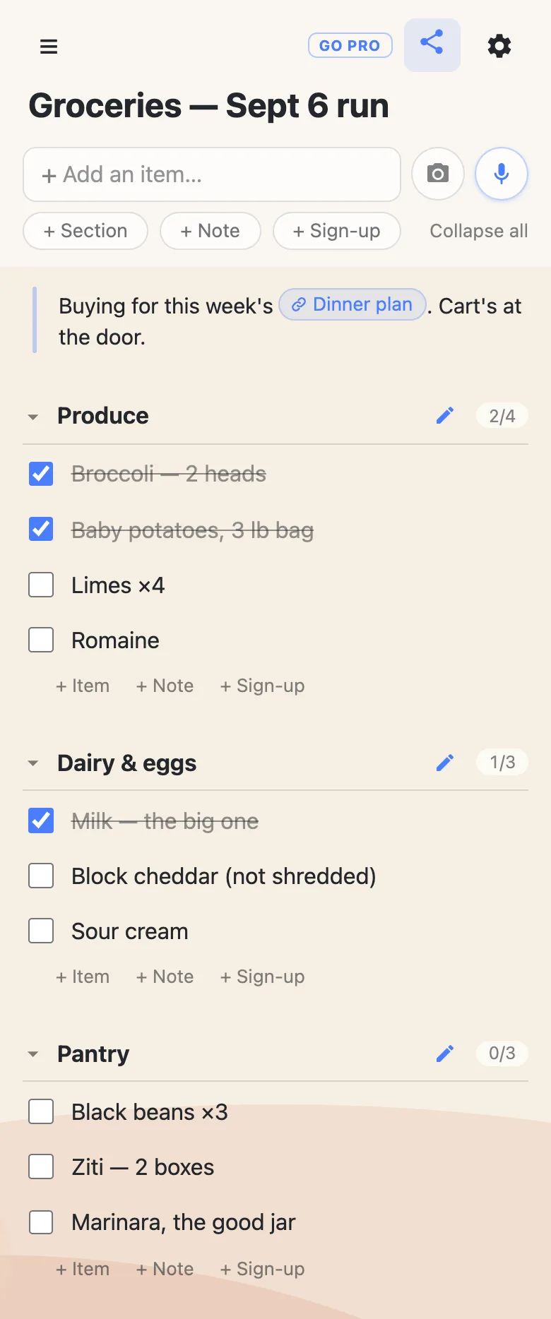 A phone showing a list titled &ldquo;Groceries &mdash; Sept 6 run&rdquo;. A note at the top reads &ldquo;Buying for this week&rsquo;s Dinner plan&rdquo; with Dinner plan as a chip. Sections for Produce (2/4), Dairy & eggs (1/3) and Pantry (0/3) hold rows like Limes ×4 and Marinara, the good jar, with bought rows ticked and struck through.