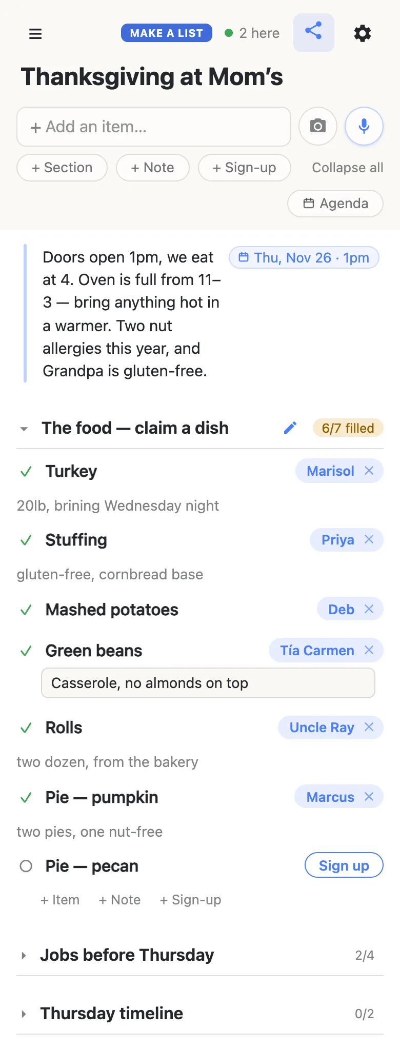A relative’s phone showing the same Thanksgiving at Mom’s list, with “2 here” and a green dot in the header. Tía Carmen has just signed up for Green beans — her name chip sits on the row — and is typing “Casserole, no almonds on top” into the note box beneath it. The food section now reads 6/7 filled; only Pie — pecan still shows a Sign up button.