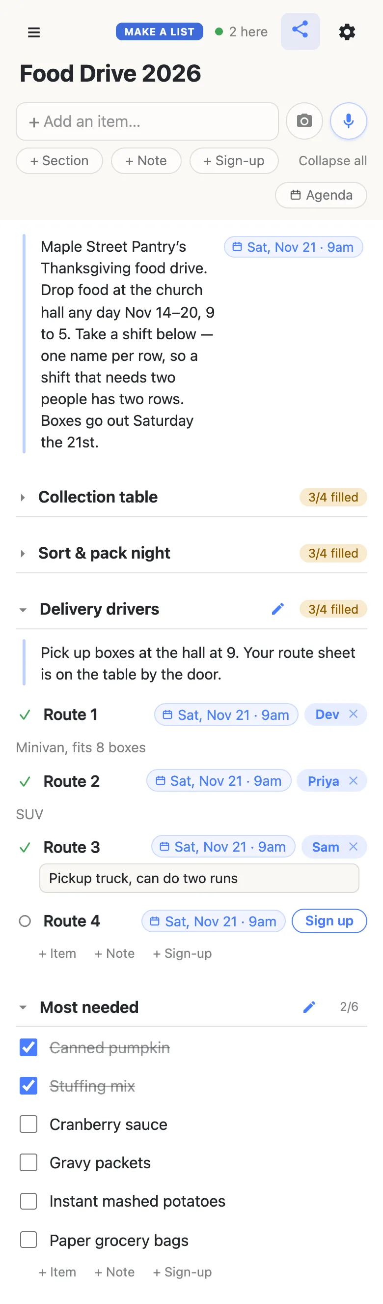 A volunteer’s phone showing the same Food Drive 2026 list, with “2 here” and a green dot in the header. The note and its Sat, Nov 21 · 9am chip sit at the top; Collection table and Sort & pack night are folded shut, each reading 3/4 filled. Delivery drivers is open and now reads 3/4 filled: a note says Pick up boxes at the hall at 9. Your route sheet is on the table by the door. Dev has Route 1 (“Minivan, fits 8 boxes”), Priya Route 2 (“SUV”), and Sam has just signed up for Route 3 and is typing “Pickup truck, can do two runs” into the note box beneath it; Route 4 shows a Sign up button. Below, Most needed reads 2/6: Canned pumpkin and Stuffing mix are ticked and struck through, and Cranberry sauce, Gravy packets, Instant mashed potatoes and Paper grocery bags are still unticked.