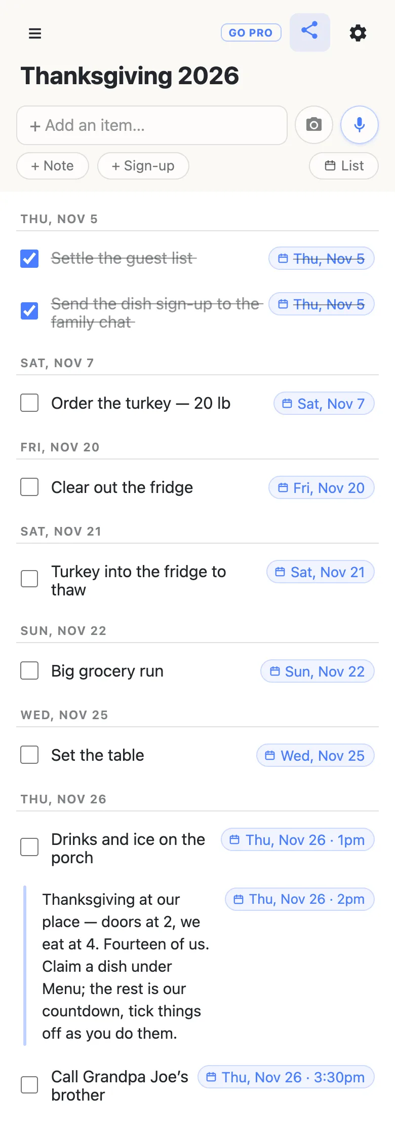 The same Thanksgiving 2026 list in Agenda view, with a List button where the Agenda button was. Rows are grouped under date headings. Thu, Nov 5: Settle the guest list and Send the dish sign-up to the family chat, both ticked and struck through. Sat, Nov 7: Order the turkey — 20 lb. Fri, Nov 20: Clear out the fridge. Sat, Nov 21: Turkey into the fridge to thaw. Sun, Nov 22: Big grocery run. Wed, Nov 25: Set the table. Thu, Nov 26: Drinks and ice on the porch at 1pm, the note “Thanksgiving at our place — doors at 2, we eat at 4” at 2pm, and Call Grandpa Joe’s brother at 3:30pm.